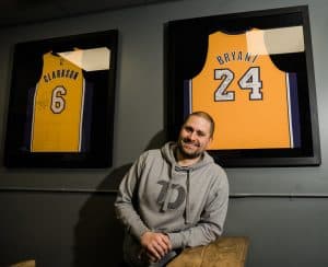 Tim DiFrancesco posing with Kobe Bryant and Jordan Clarkson framed jerseys