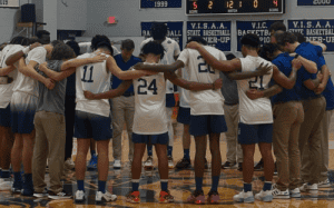 Blue Ridge basketball players and coaches huddling on the court