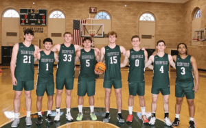 Deerfield Academy basketball players celebrate a big win, walking off the court with energy and smiles after a home game victory.