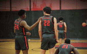 Hun School basketball player pats teammate on the back during a game for encouragement.