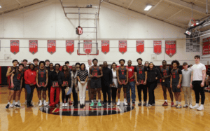 Hun School basketball players and families stand together on the court during Senior Night.