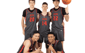 Hun School senior basketball players pose together in black and red uniforms for a team portrait.