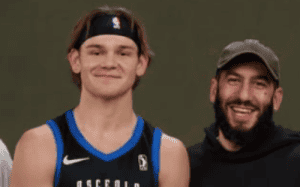 Orlando Magic player holding a trophy alongside Dan Poneman, celebrating basketball success.