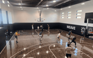 Players training on the WEAVE basketball court during a workout session focused on NIL-era player development.