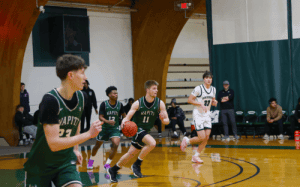 Winchendon School basketball players push the ball in transition during a fastbreak offensive play in a prep school game