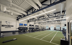 Hotchkiss School athletics weight room and training facility with turf track and strength equipment.