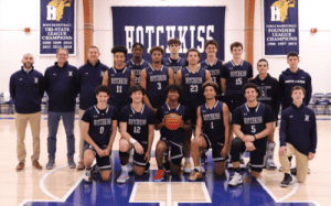 Hotchkiss School boys basketball team group photo on the court, showcasing players and coaches in navy uniforms.