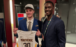 Montverde Academy alum holding team jersey alongside mentor at NBA Draft event.