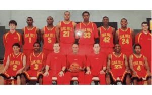 Oak Hill Academy basketball team photo in red uniforms with coaches and players during a championship season