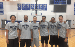 Basketball coaches and staff at a hoop training camp, supporting player development and recruiting success.