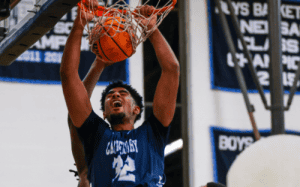 Canterbury School basketball player dunks the ball with intensity during a prep school game, showcasing athleticism and strength under the rim.
