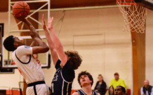 Hargrave Military Academy basketball player goes up for a contested shot against Atlantic Shores defenders during the state tournament opening round.