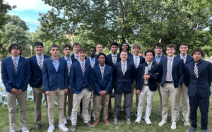 The Perkiomen School boys basketball team poses outdoors in blue blazers and striped ties, representing unity, discipline, and the values of prep school basketball.