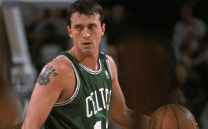 A professional basketball player in a green Celtics jersey focuses during gameplay, symbolizing dedication and mental toughness in athletics.